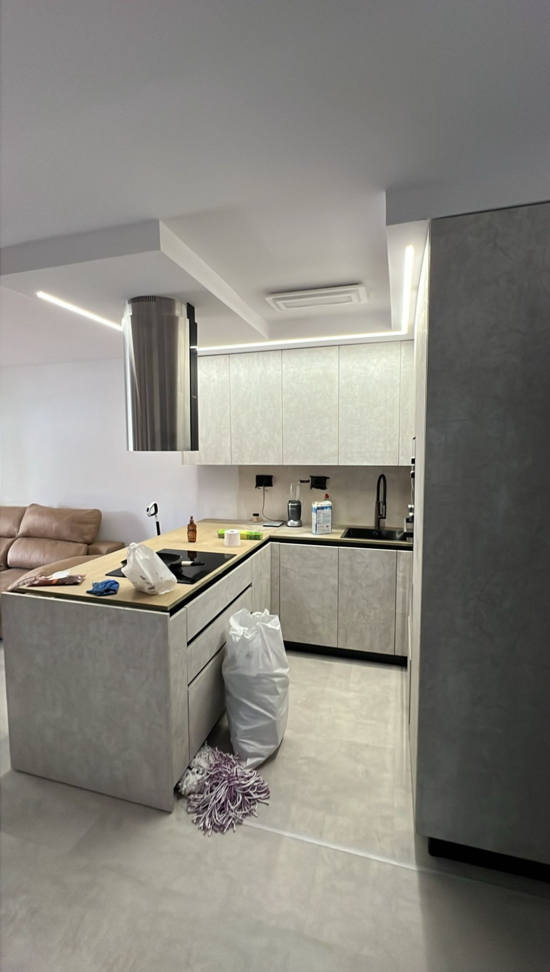 Cucina a U con piano cottura a induzione sull isola e ante effetto cemento